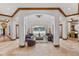 Bright living room showcasing travertine floors, rich wood trim, and a serene pool view at 1965 Lake Markham Preserve Trl, Sanford, FL 32771