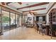 Expansive living room featuring a bar, travertine floors, and sliding glass doors to the outdoor living space at 1965 Lake Markham Preserve Trl, Sanford, FL 32771