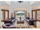 Bright living room offering a serene pool view and travertine floors at 1965 Lake Markham Preserve Trl, Sanford, FL 32771