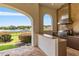 Outdoor kitchen with granite counters, stainless steel appliances, and lake views at 1965 Lake Markham Preserve Trl, Sanford, FL 32771