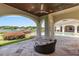 Covered outdoor living area overlooking the pool and lake, perfect for relaxation and entertaining at 1965 Lake Markham Preserve Trl, Sanford, FL 32771