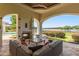 Covered patio with fireplace and comfortable seating overlooking lake at 1965 Lake Markham Preserve Trl, Sanford, FL 32771