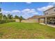 Large backyard with grassy area and privacy fence at 2003 American Beech Pkwy, Ocoee, FL 34761