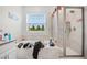 Bathroom with soaking tub, shower, and window with natural light at 2003 American Beech Pkwy, Ocoee, FL 34761