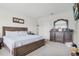 Primary bedroom with king-size bed and dresser at 2003 American Beech Pkwy, Ocoee, FL 34761