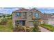 Two-story house with blue shutters and stone accents at 2003 American Beech Pkwy, Ocoee, FL 34761