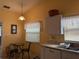 Cozy kitchen nook with white cabinets and a small table at 871 Reflections E Loop, Winter Haven, FL 33884