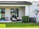 Cozy covered back patio with seating and sliding glass doors for seamless indoor-outdoor living at 15259 Willow Arbor Cir, Orlando, FL 32824