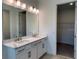 Bathroom featuring a double vanity with marble countertop and modern lighting at 2560 Cavanaugh Dr, Orlando, FL 32817