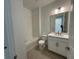 Well-lit bathroom with tub/shower combination, and large vanity with modern fixtures at 2560 Cavanaugh Dr, Orlando, FL 32817