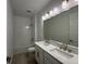 Bathroom featuring a double vanity with marble countertop and modern lighting at 2560 Cavanaugh Dr, Orlando, FL 32817