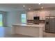 Modern kitchen with stainless steel appliances, white cabinets, and a large island at 2560 Cavanaugh Dr, Orlando, FL 32817