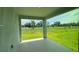 A covered patio overlooking a grassy backyard and a view of the lake at 2560 Cavanaugh Dr, Orlando, FL 32817