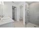 Bright bathroom featuring double sinks with stone countertop, modern shower with glass door, and toilet room at 2585 Cavanaugh Dr, Orlando, FL 32817