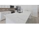 Close-up of a kitchen island with white countertops, stainless steel sink, and modern fixtures at 2585 Cavanaugh Dr, Orlando, FL 32817