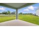 Covered patio overlooking expansive lawn and landscaping at 2585 Cavanaugh Dr, Orlando, FL 32817