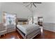 Spacious bedroom with wood floors and an ensuite bathroom at 7749 Water Oak Ct, Kissimmee, FL 34747