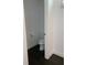 Small, clean bathroom with toilet and dark hardwood floors at 816 Johns Point Dr, Oakland, FL 34787