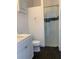 Clean bathroom with white vanity, shower, and dark floors at 816 Johns Point Dr, Oakland, FL 34787