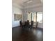 Elegant dining room features a dark wood floor, glass table, and modern chandelier at 816 Johns Point Dr, Oakland, FL 34787