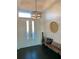 Bright entryway with dark hardwood floors, bench, and modern light fixture at 816 Johns Point Dr, Oakland, FL 34787