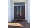 Dark brown double front doors with glass panels and a brick walkway at 816 Johns Point Dr, Oakland, FL 34787