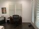 Bright home office features built-in desk, large window with plantation shutters, and dark hardwood floors at 816 Johns Point Dr, Oakland, FL 34787