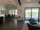 Contemporary living room flows to the dining area and offers beautiful backyard pool views at 816 Johns Point Dr, Oakland, FL 34787