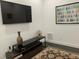 Living room featuring a TV, decor, and a patterned rug on hardwood flooring at 816 Johns Point Dr, Oakland, FL 34787