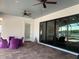 Covered patio with lake view, ceiling fans, and comfortable seating at 816 Johns Point Dr, Oakland, FL 34787