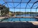 A luxurious pool is surrounded by a screened enclosure offering stunning lake views at 816 Johns Point Dr, Oakland, FL 34787