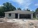 New single-story home featuring an attached garage on a spacious lot ready for finishing at 1608 Jefferson Dr, Mount Dora, FL 32757