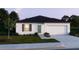Beautiful single-story home featuring a two-car garage, dark roof, neutral paint, and landscaping at 1608 Jefferson Dr, Mount Dora, FL 32757