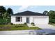 Beautiful single-story home featuring a two-car garage, dark roof, neutral paint, and landscaping at 1608 Jefferson Dr, Mount Dora, FL 32757