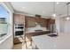 Modern kitchen with stainless steel appliances, a center island with quartz countertops, and stylish pendant lighting at 1694 Pinecliff Dr, Apopka, FL 32703