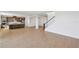 Open-concept living space featuring a kitchen, dining area, staircase and light wood flooring throughout at 1694 Pinecliff Dr, Apopka, FL 32703