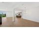 Bright open-concept living room with wood floors adjacent to the kitchen and sliding doors to the backyard at 1694 Pinecliff Dr, Apopka, FL 32703