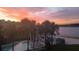 Sunset view of the community pool and beach cabana enhance the appeal of this waterfront home at 4113 Fairview Vista Pt # 308, Orlando, FL 32804