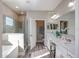 Bright bathroom features a glass enclosed shower, soaking tub, and double sink vanity at 1685 Andover Ridge Dr, Deland, FL 32720