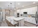 Modern kitchen featuring white cabinetry, an island with bar seating, stainless steel appliances, and stylish backsplash at 1685 Andover Ridge Dr, Deland, FL 32720