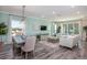 Cozy living room featuring neutral tones, hardwood flooring, modern furnishings, and large windows at 1685 Andover Ridge Dr, Deland, FL 32720