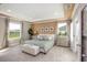 Serene main bedroom featuring a tray ceiling, neutral tones, plush carpeting, and backyard views at 1685 Andover Ridge Dr, Deland, FL 32720