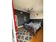 Stylish bedroom featuring a sleek bed, accent wall, and decorative ceiling fan at 1010 Strathmore Dr, Orlando, FL 32806