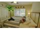 Bright bedroom features tropical accents, comfortable bed, and natural light from the window at 1010 Strathmore Dr, Orlando, FL 32806