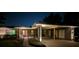 Charming home exterior with covered parking, a red front door, and manicured landscaping at 1010 Strathmore Dr, Orlando, FL 32806