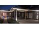 Charming home featuring a brick carport, manicured landscaping, and a welcoming red front door at 1010 Strathmore Dr, Orlando, FL 32806