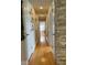 Bright hallway with hardwood floors, decorative wall accents, and white doors at 1010 Strathmore Dr, Orlando, FL 32806