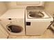Modern laundry room showcasing a side-by-side washer and dryer at 1010 Strathmore Dr, Orlando, FL 32806