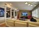 Open-concept living room with stone accent wall, modern furniture, and ample natural light at 1010 Strathmore Dr, Orlando, FL 32806