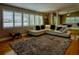 Bright living room featuring modern furniture, large windows, and hardwood flooring at 1010 Strathmore Dr, Orlando, FL 32806